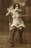 (POSTCARDS) An album containing 54 risqué real photo postcards and photographs featuring female subjects,